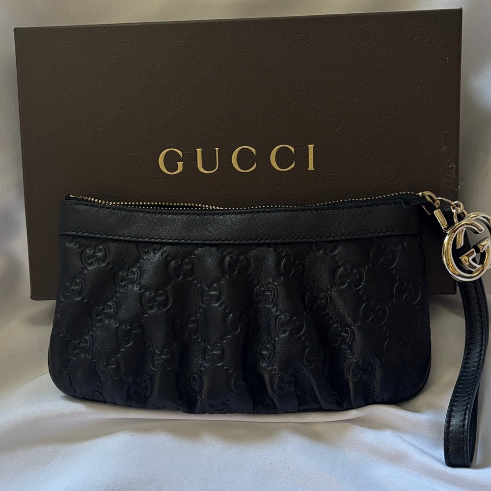 Purchased in Italy Gucci Black Embossed Leather Wristlet with Gold GG Charm